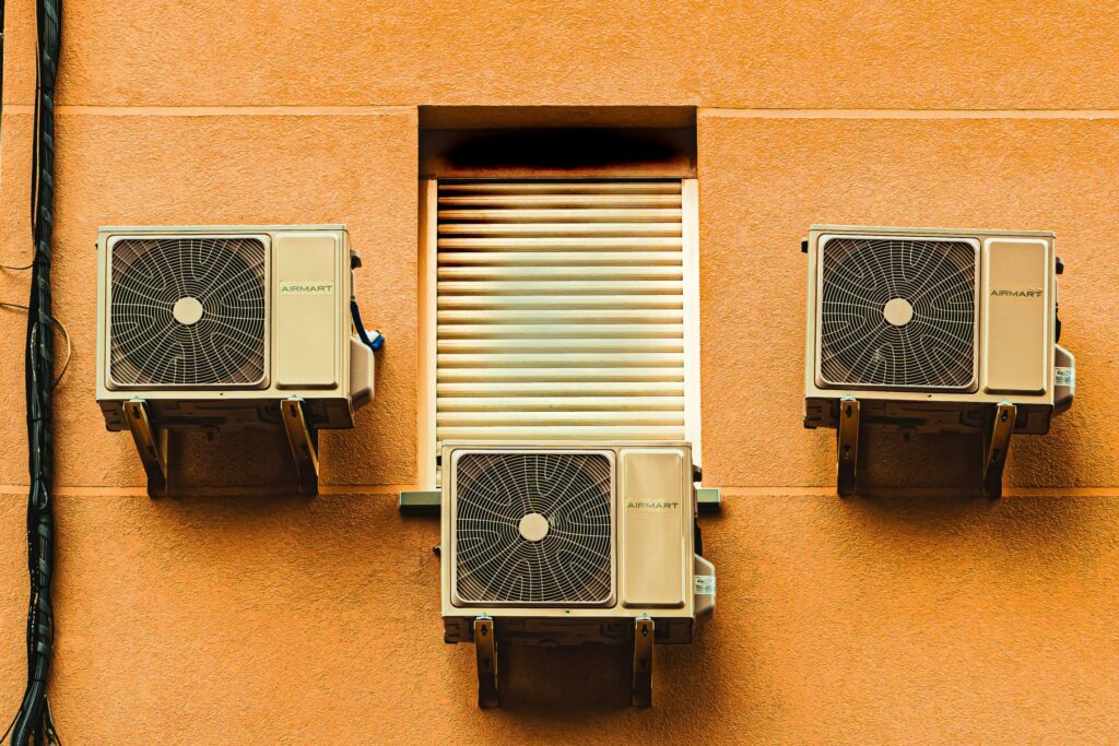 Image of air conditioners on the side of a building taken in 2020 by Jose Antonio Gallego Vázquez via Unsplash